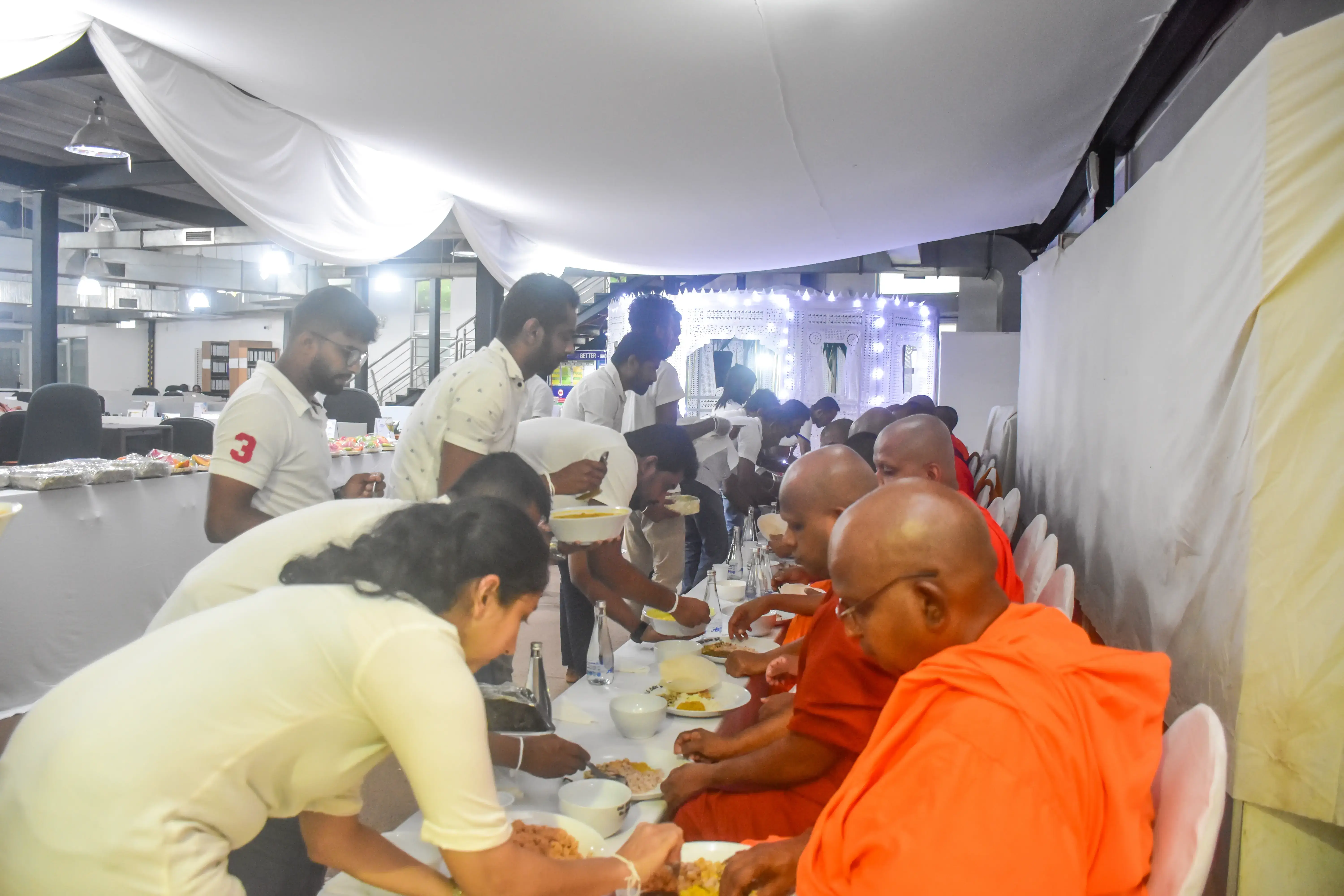 Hirdaramani employees serving foods for monks