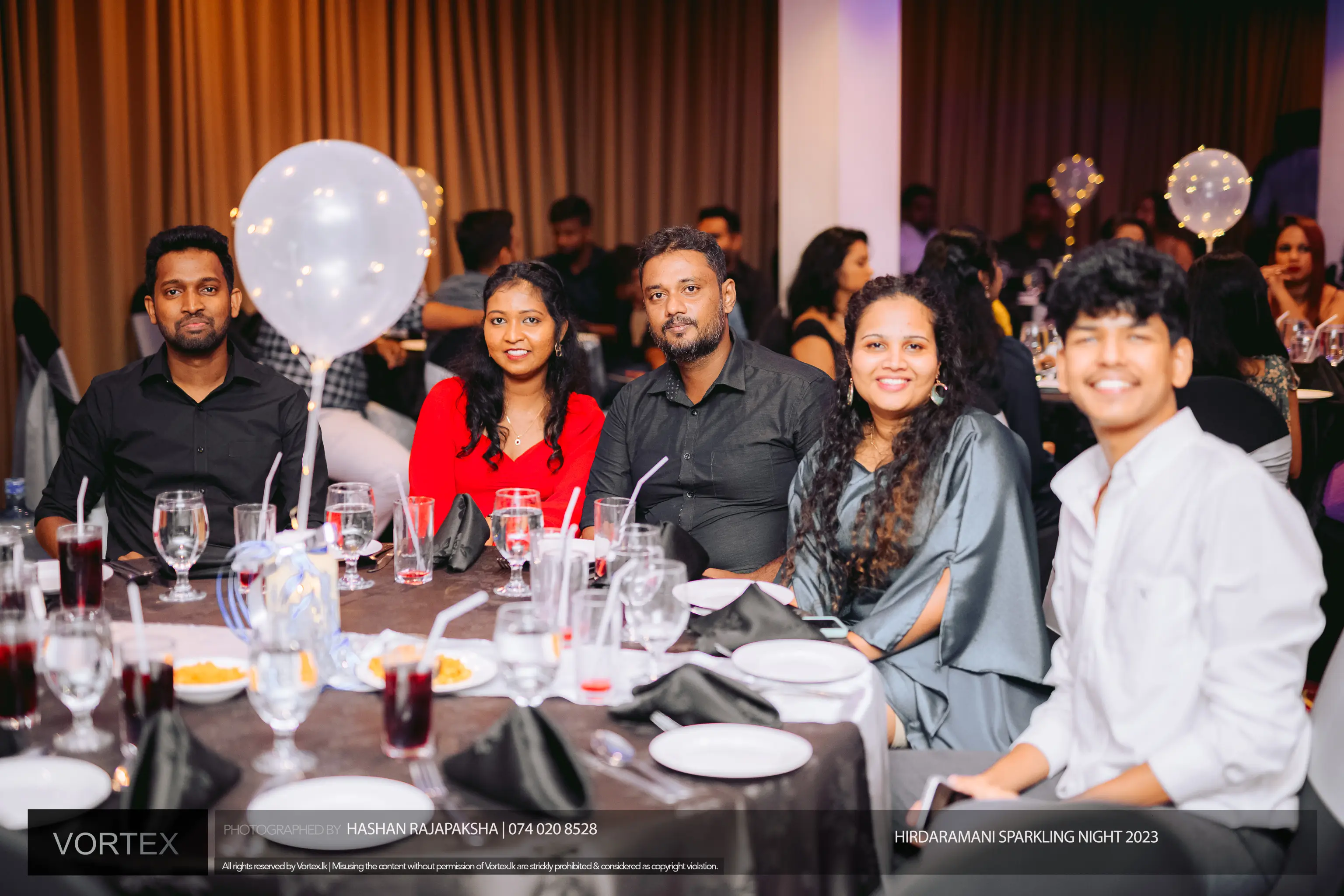 Two female and three male employees seated in a table in an event organized by Hirdaramani