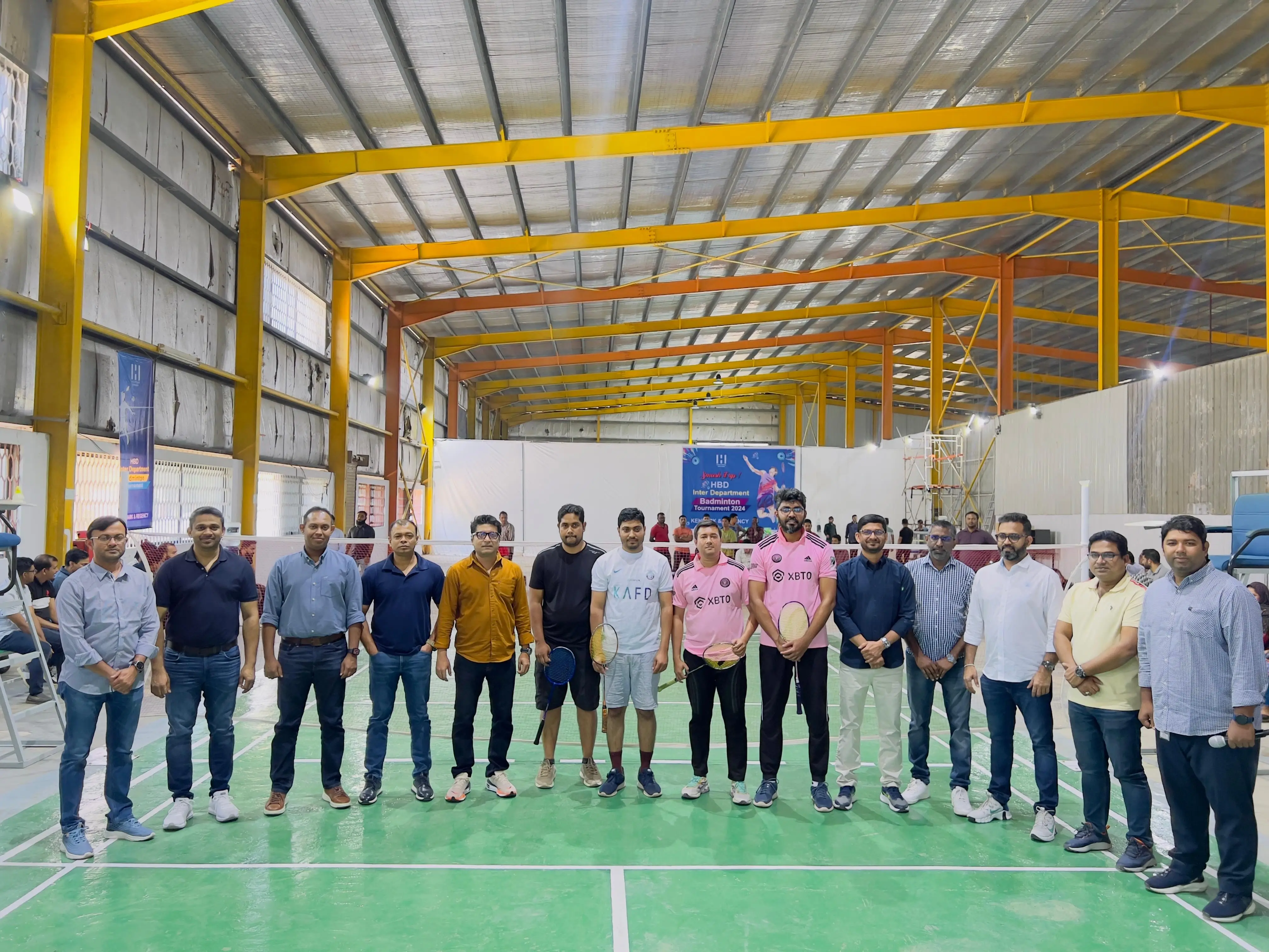 Participants of the inter departmental badminton championship in a group photo inside the indoor badminton premises