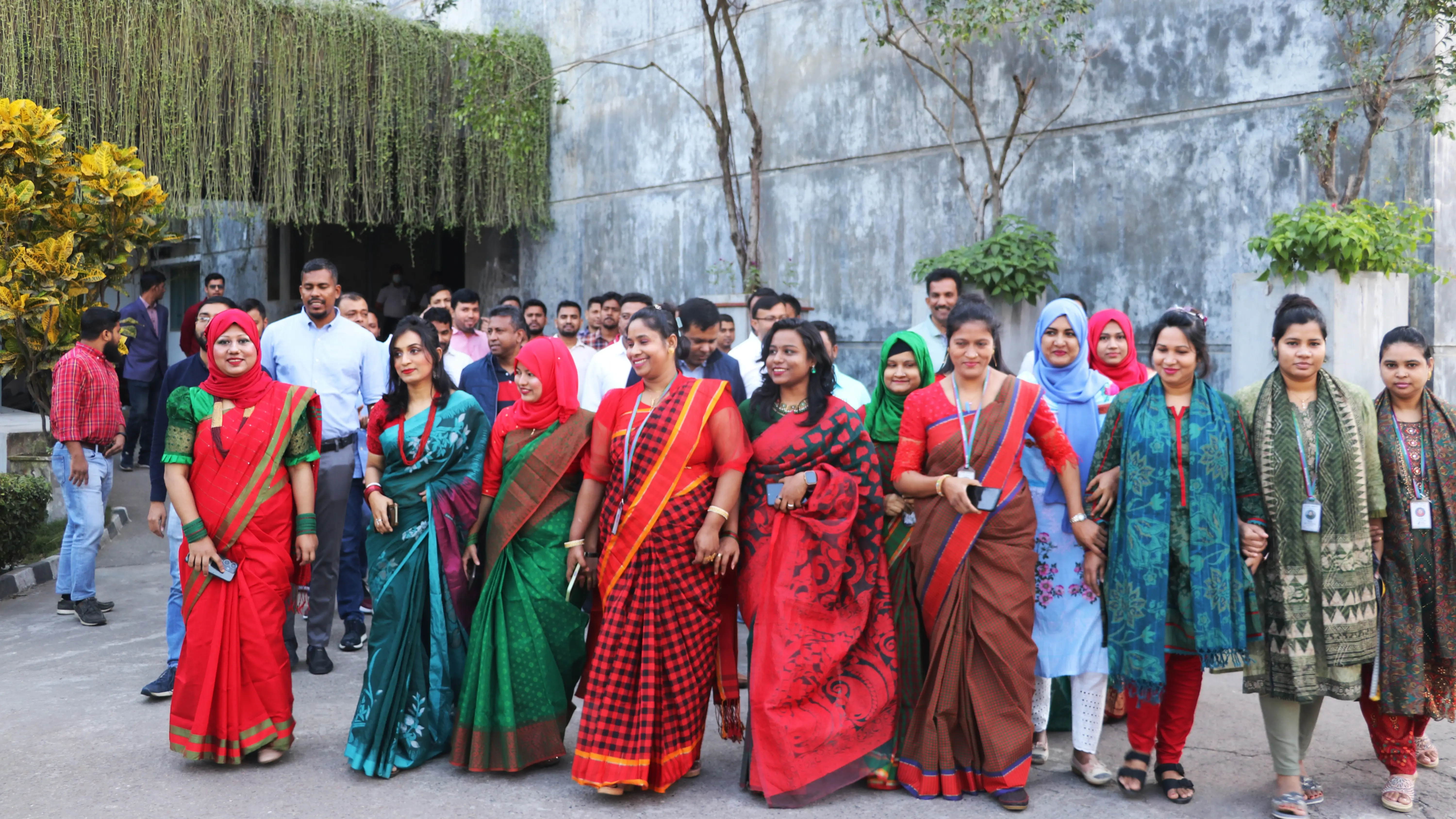 Few female employees of Apparel  factory of Hirdaramani in Bangladesh wearing sarees and holding hands to celebrate Victory day