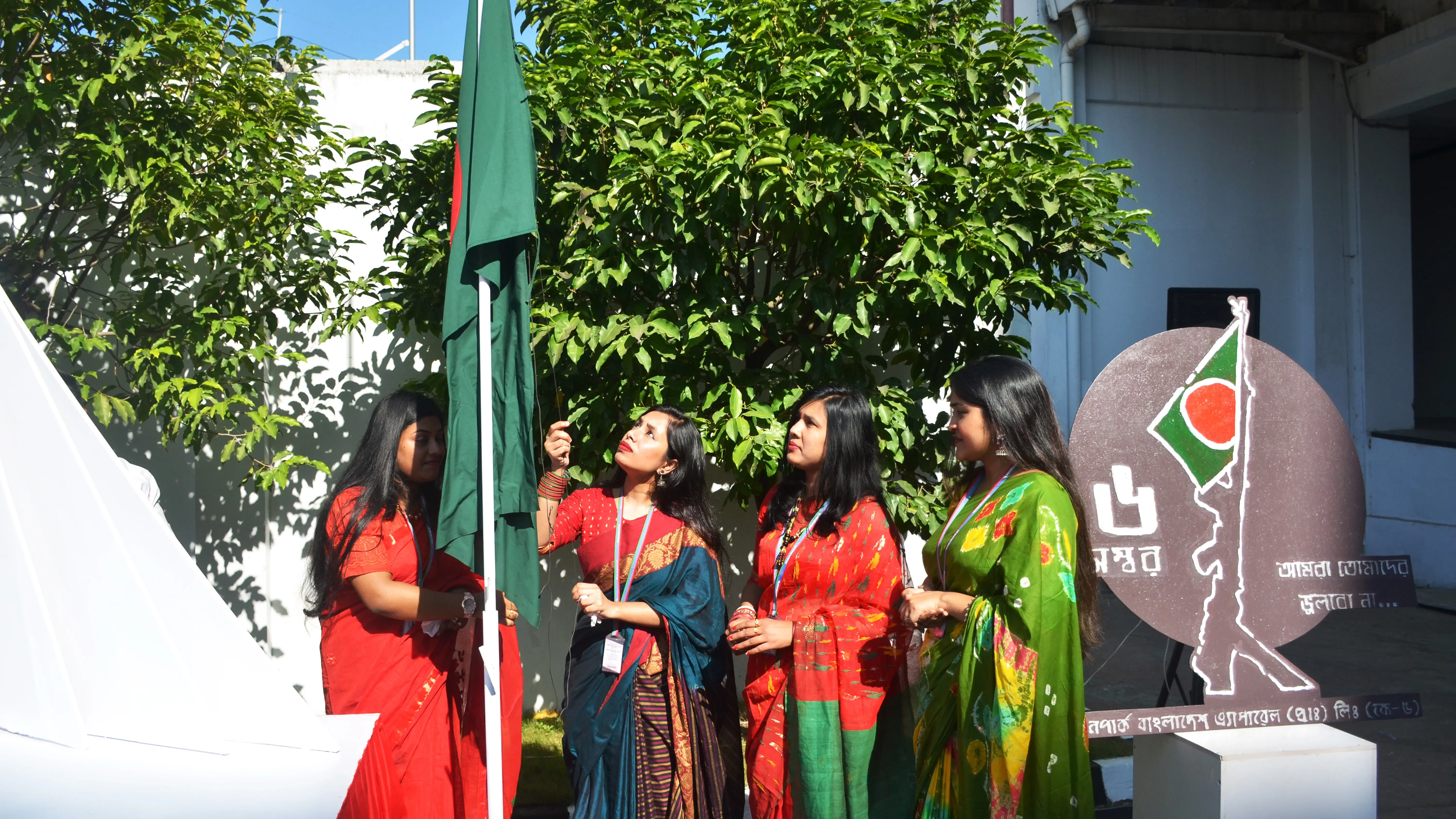 Female employees of Bangladesh Hirdaramani garment factory hosing the national flag