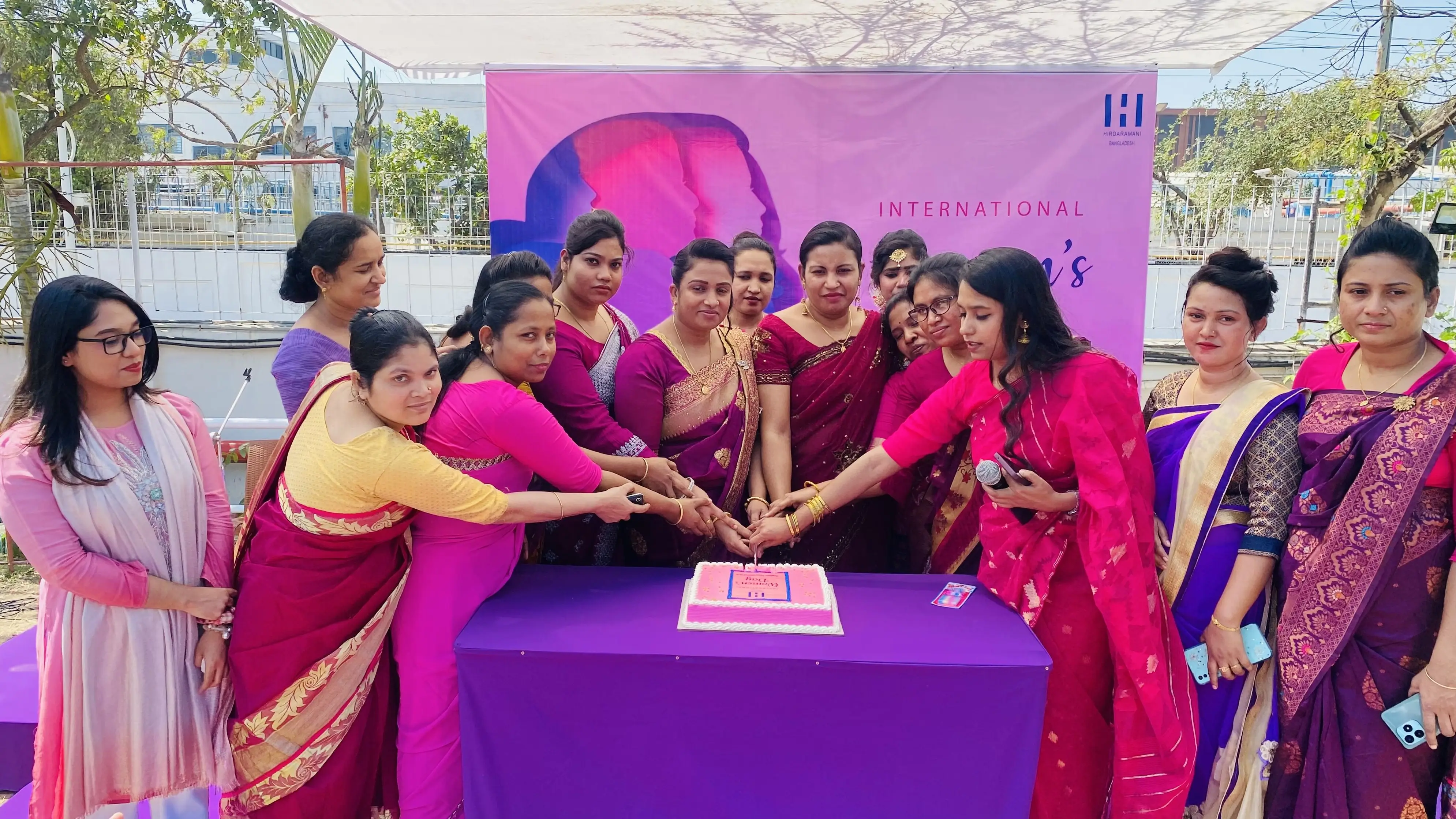 Female employees of hirdaramani apparel in cutting a cake for world women day celebration