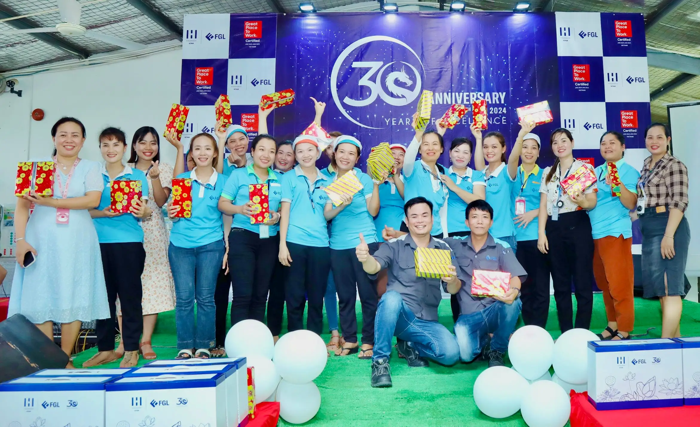 Employees with the presents in a group photo