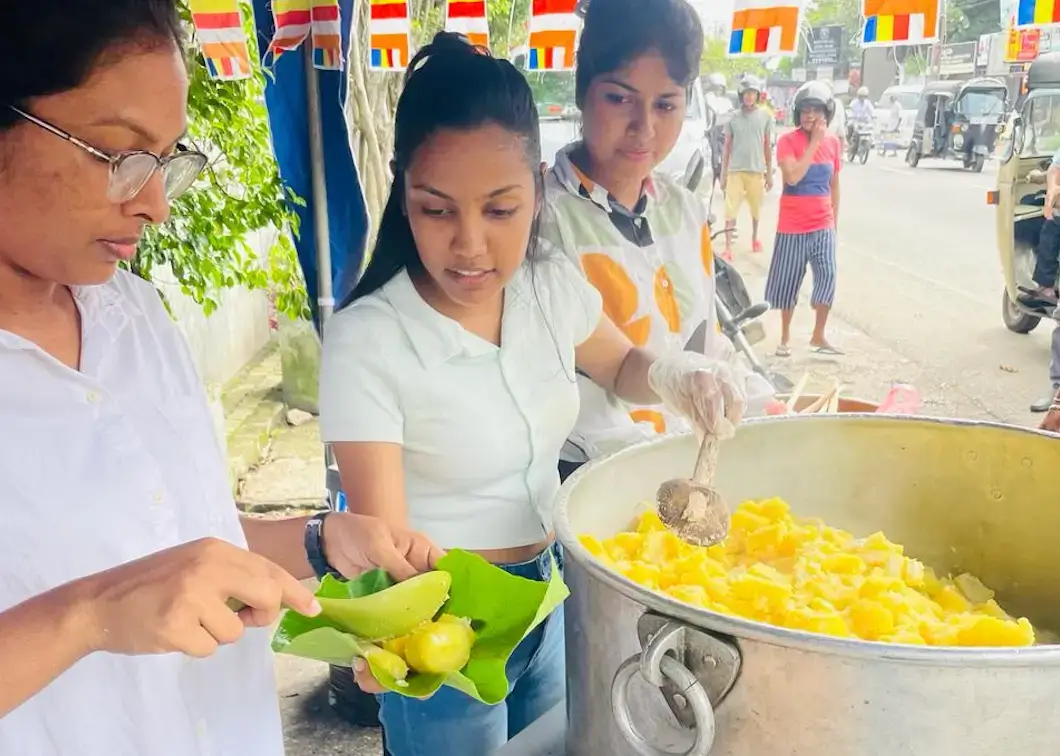 Three ladies employees of Hirdaramani serving food in a stall