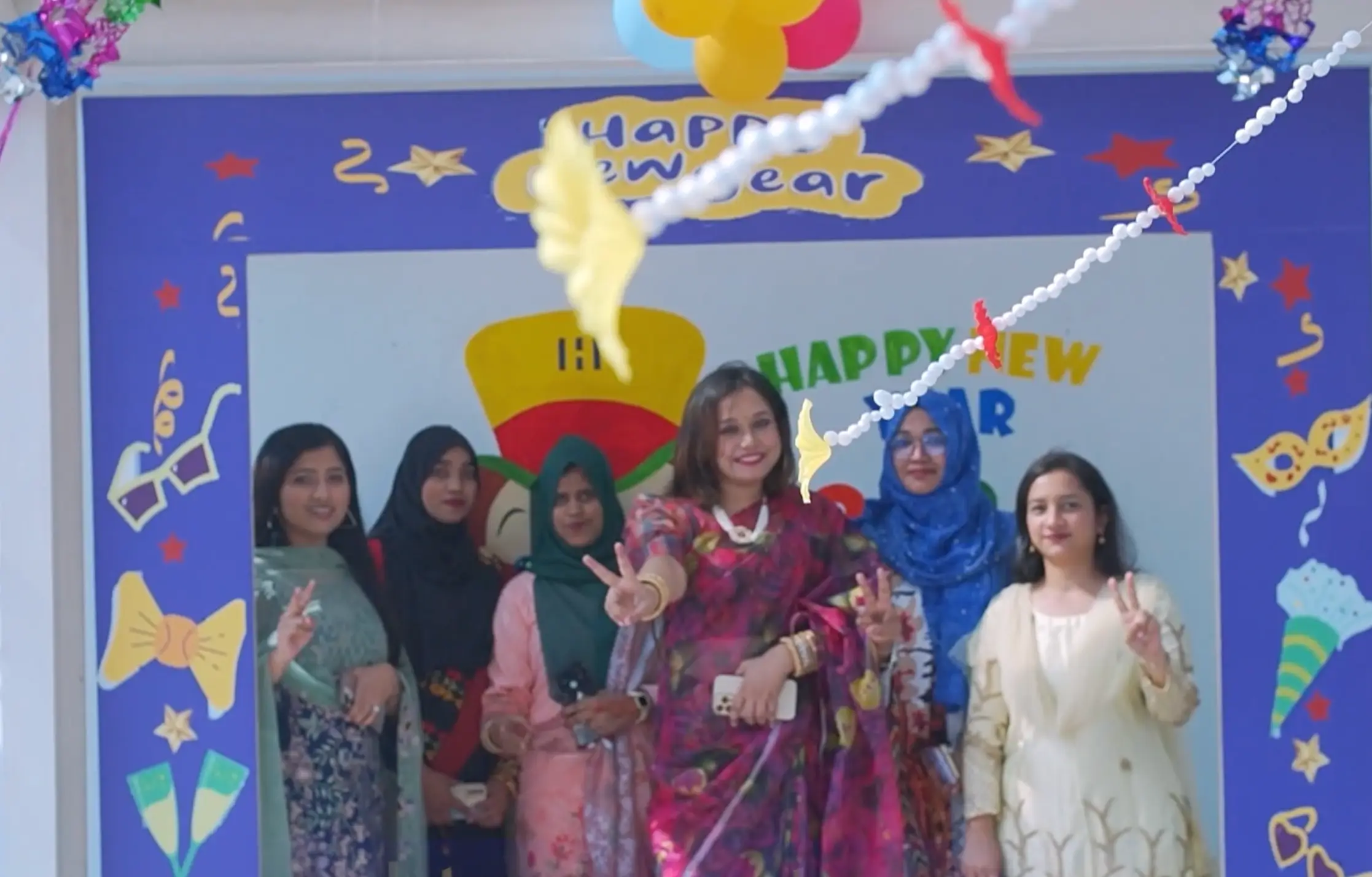 Few female employees of Hiradaramani garment’s in a photo booth posing for a photograph